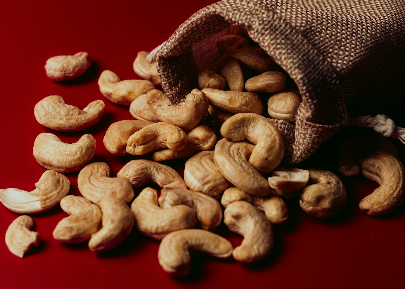Cashew nuts spilling from a jute export sack