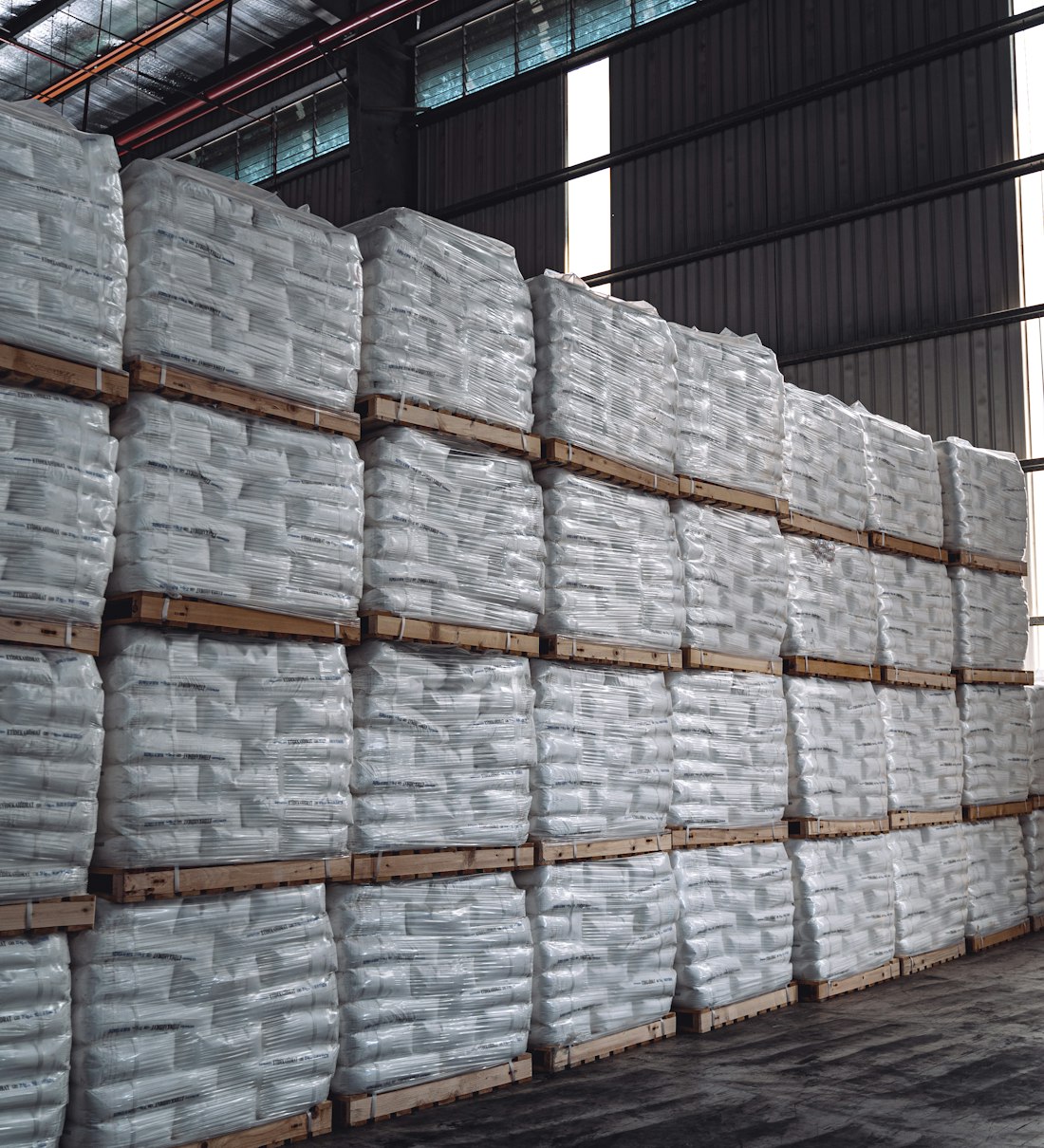 Palletised export bags stacked in a commodity warehouse