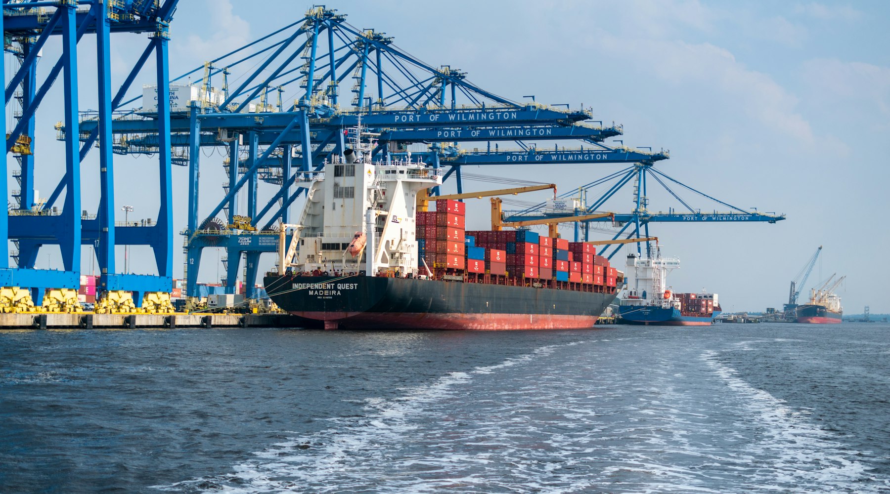 A container vessel alongside at a working berth